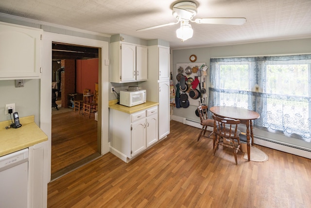 168 Beech Hill Rd, Auburn, ME 04210 - kitchen with white appliances, light countertops, white cabinets, crown molding, and light wood-type flooring