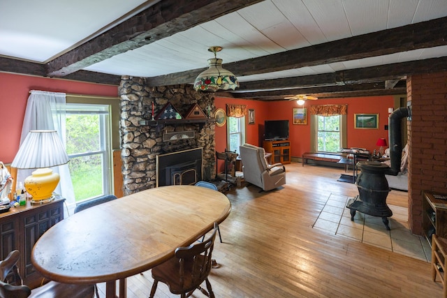 168 Beech Hill Rd, Auburn, ME 04210 - dining room featuring wood-type flooring, beamed ceiling, a fireplace, ceiling fan, and a baseboard radiator
