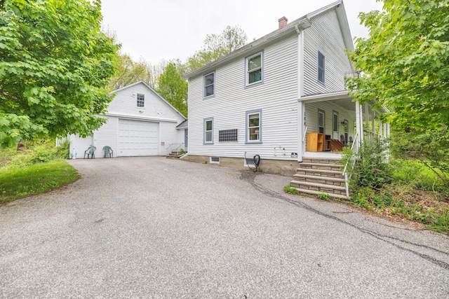 168 Beech Hill Rd, Auburn, ME 04210 - view of front of property with a garage, an outdoor structure, a chimney, and a porch