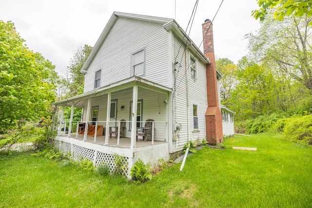 168 Beech Hill Rd, Auburn, ME 04210 - view of front of house featuring a chimney, a front lawn, and a porch