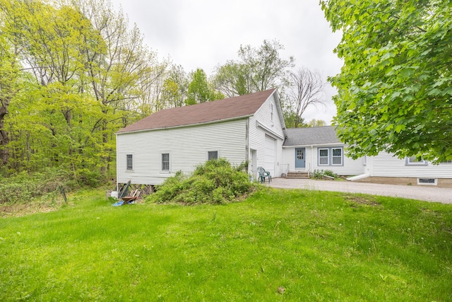 168 Beech Hill Rd, Auburn, ME 04210 - view of side of property with a lawn, entry steps, a garage, a patio area, and a shingled roof