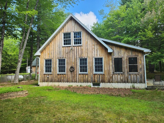 227 Brooks Pond Dr, Corinna, ME 04928 - view of side of property featuring a lawn and board and batten siding