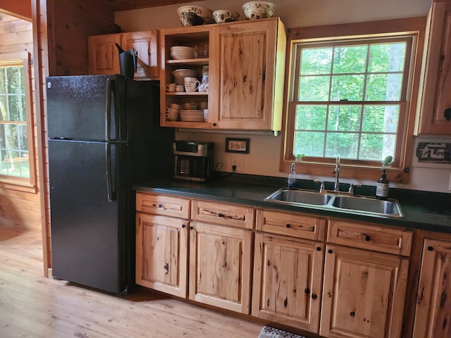 227 Brooks Pond Dr, Corinna, ME 04928 - kitchen with a sink, freestanding refrigerator, dark countertops, and plenty of natural light