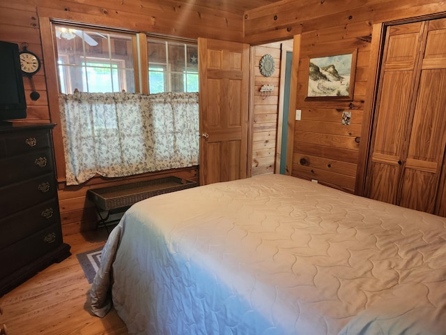 227 Brooks Pond Dr, Corinna, ME 04928 - bedroom with wooden walls and light wood finished floors