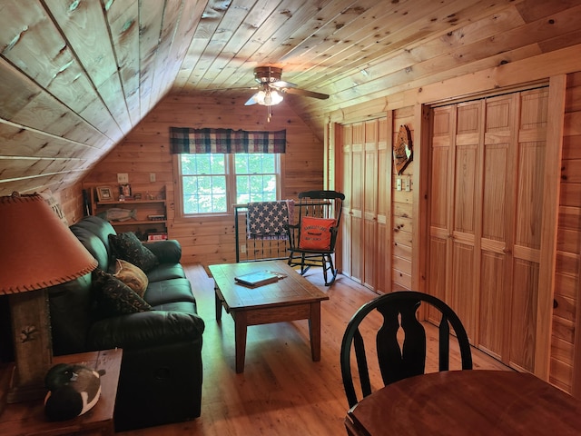 227 Brooks Pond Dr, Corinna, ME 04928 - living area featuring wooden walls, wood ceiling, light wood-style floors, vaulted ceiling, and ceiling fan