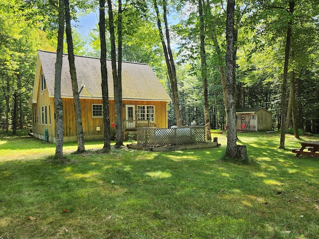 227 Brooks Pond Dr, Corinna, ME 04928 - view of front of property with an outdoor structure, a shed, a front lawn, and a shingled roof