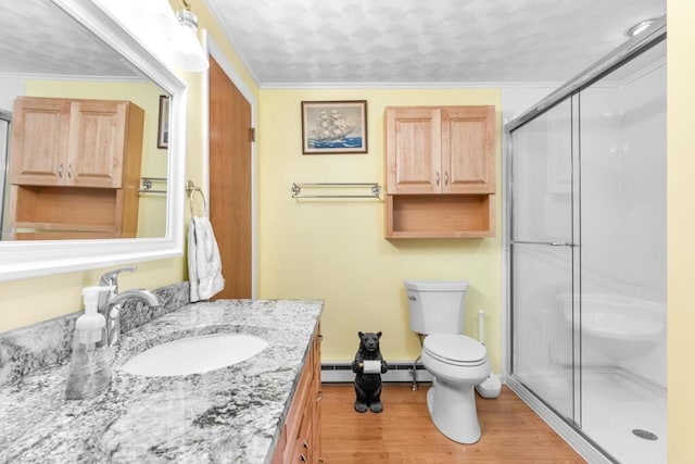 73 Wards Cove Rd, Standish, ME 04084 - full bath featuring a baseboard heating unit, a stall shower, wood finished floors, toilet, and vanity