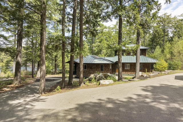 389 Castle Island Rd, Belgrade, ME 04917 - view of front facade featuring a standing seam roof, metal roof, a chimney, and a porch