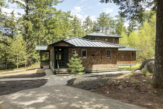 389 Castle Island Rd, Belgrade, ME 04917 - view of front facade featuring a standing seam roof, metal roof, and a chimney