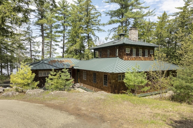389 Castle Island Rd, Belgrade, ME 04917 - view of front of home featuring a standing seam roof, metal roof, and a chimney
