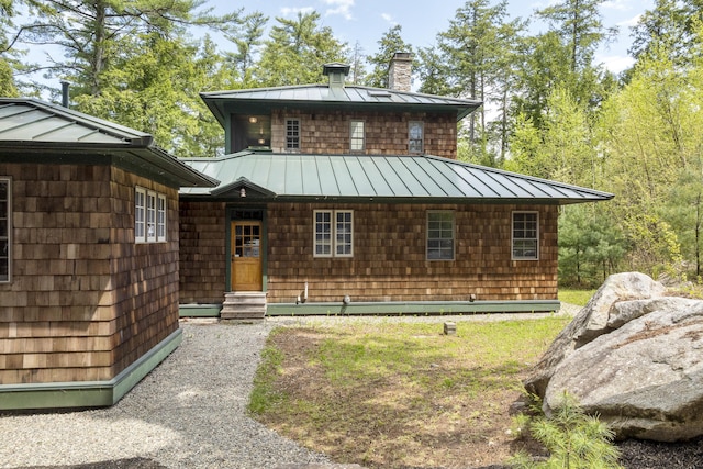 389 Castle Island Rd, Belgrade, ME 04917 - view of front facade with a standing seam roof, metal roof, a chimney, and entry steps