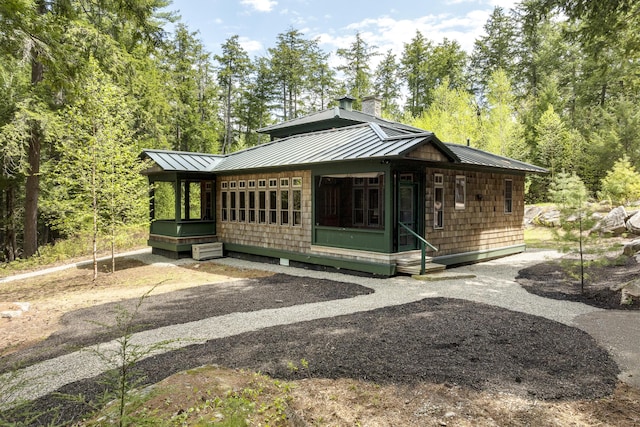 389 Castle Island Rd, Belgrade, ME 04917 - view of front of house with a standing seam roof, a chimney, and metal roof