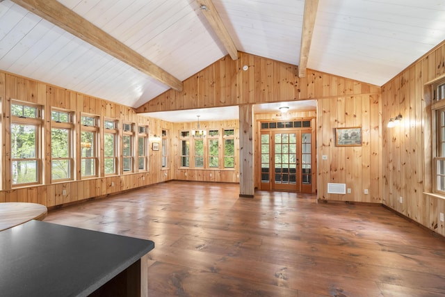 389 Castle Island Rd, Belgrade, ME 04917 - unfurnished living room with wooden walls, hardwood / wood-style flooring, healthy amount of natural light, and baseboards