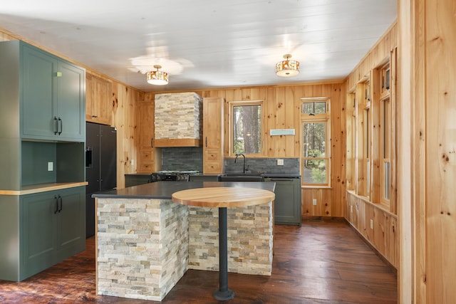 389 Castle Island Rd, Belgrade, ME 04917 - kitchen with dishwasher, dark wood-type flooring, a sink, dark countertops, and wood walls