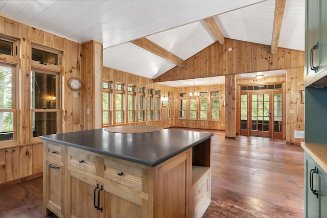 389 Castle Island Rd, Belgrade, ME 04917 - kitchen featuring wood walls, dark countertops, a center island, dark wood-type flooring, and french doors