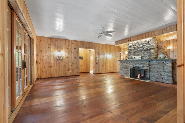 389 Castle Island Rd, Belgrade, ME 04917 - unfurnished living room featuring wooden walls, a ceiling fan, hardwood / wood-style floors, a fireplace, and wooden ceiling