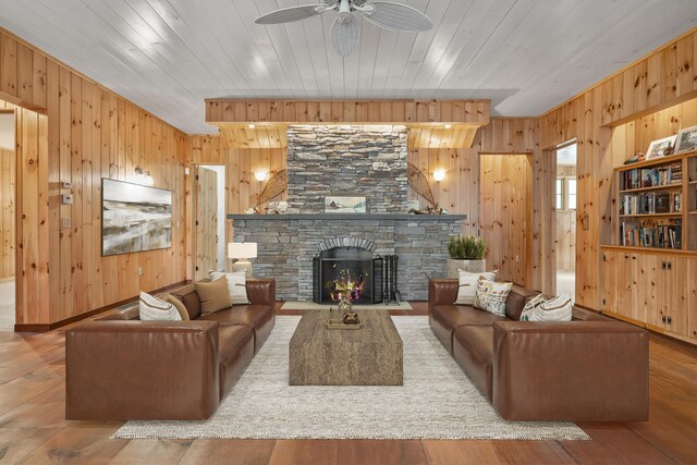 389 Castle Island Rd, Belgrade, ME 04917 - living room featuring wood walls, ceiling fan, wood finished floors, a fireplace, and wooden ceiling