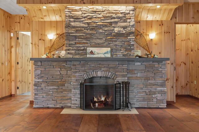 389 Castle Island Rd, Belgrade, ME 04917 - detailed view of wood walls, wood finished floors, and a stone fireplace