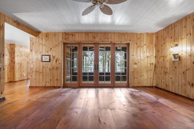 389 Castle Island Rd, Belgrade, ME 04917 - unfurnished room with french doors, hardwood / wood-style floors, a ceiling fan, wooden walls, and wooden ceiling