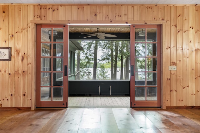 389 Castle Island Rd, Belgrade, ME 04917 - entryway with wooden walls, ceiling fan, wood finished floors, and baseboards