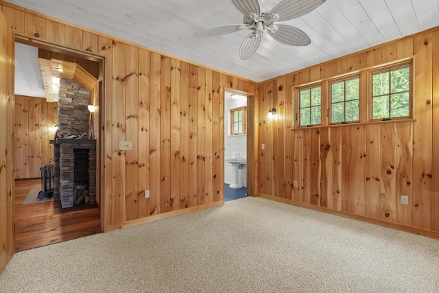389 Castle Island Rd, Belgrade, ME 04917 - carpeted spare room with a ceiling fan, wood walls, and baseboards
