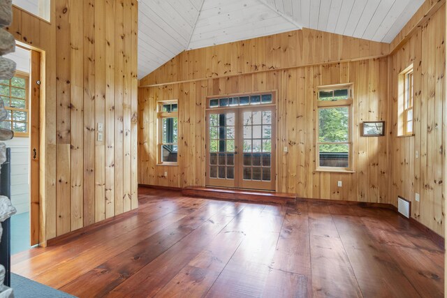 389 Castle Island Rd, Belgrade, ME 04917 - empty room featuring lofted ceiling, wood-type flooring, and wood walls