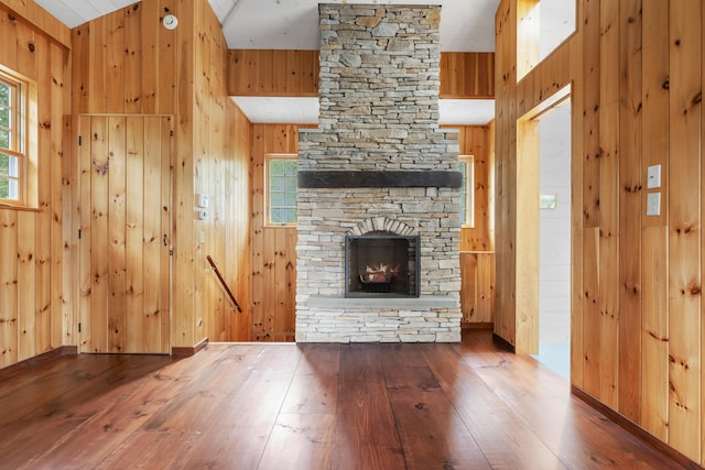 389 Castle Island Rd, Belgrade, ME 04917 - unfurnished living room featuring hardwood / wood-style floors, wood walls, and a fireplace