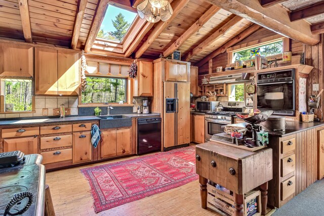 890 Salem Rd, Freeman Twp, ME 04983 - kitchen with black appliances, wood ceiling, plenty of natural light, a skylight, and dark countertops