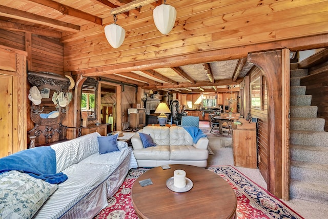 890 Salem Rd, Freeman Twp, ME 04983 - carpeted living area with wooden walls, beamed ceiling, stairway, and wooden ceiling