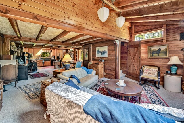 890 Salem Rd, Freeman Twp, ME 04983 - carpeted living area featuring wood walls, plenty of natural light, beam ceiling, and wooden ceiling