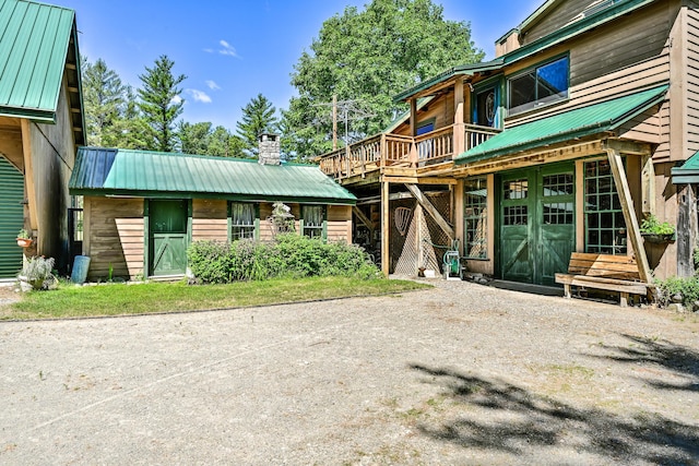 890 Salem Rd, Freeman Twp, ME 04983 - exterior space featuring metal roof, a chimney, and a wooden deck