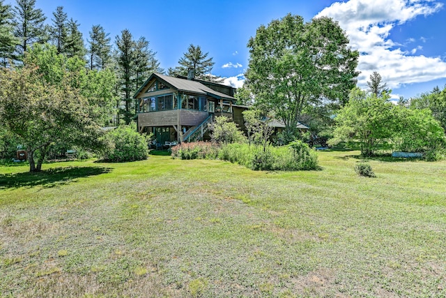 890 Salem Rd, Freeman Twp, ME 04983 - view of green lawn featuring stairs and a sunroom