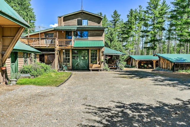 890 Salem Rd, Freeman Twp, ME 04983 - view of front of home with driveway, metal roof, and a deck