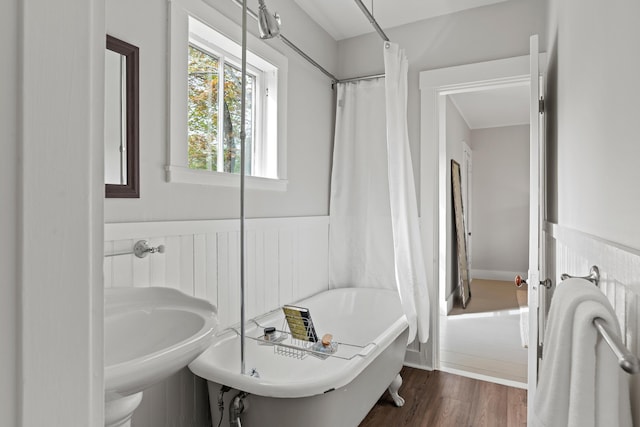 288 Foreside Rd, Falmouth, ME 04105 - full bath with a soaking tub, a wainscoted wall, wood finished floors, and a sink