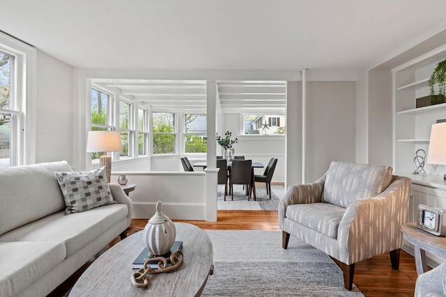 288 Foreside Rd, Falmouth, ME 04105 - living room featuring wood finished floors, healthy amount of natural light, and built in features