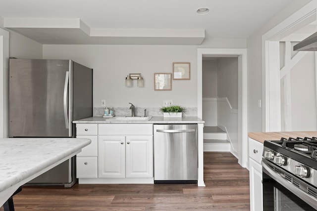 288 Foreside Rd, Falmouth, ME 04105 - kitchen featuring stainless steel appliances, a sink, light countertops, white cabinetry, and dark wood-type flooring