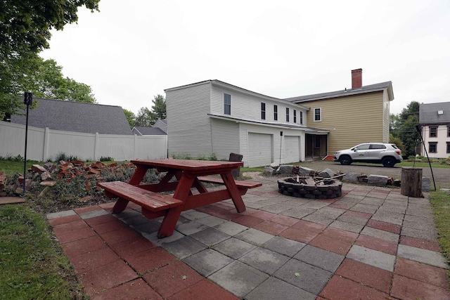7 Middle St, Hallowell, ME 04347 - view of patio with a garage and a fire pit