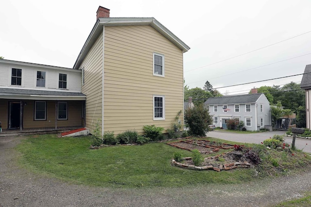 7 Middle St, Hallowell, ME 04347 - view of side of home featuring a chimney and a yard