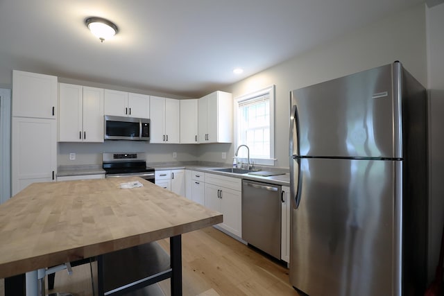 7 Middle St, Hallowell, ME 04347 - kitchen featuring stainless steel appliances, a sink, light wood-style flooring, white cabinetry, and recessed lighting