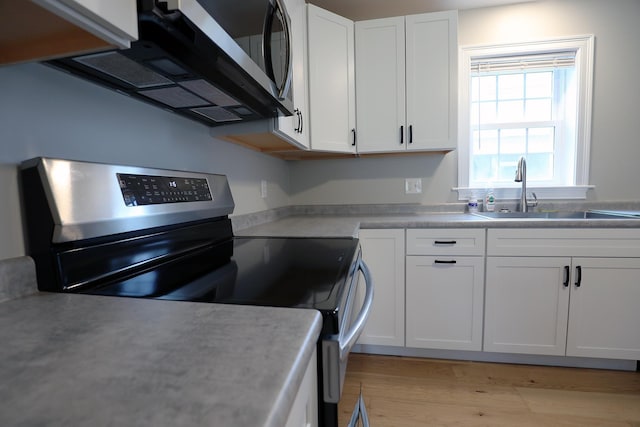 7 Middle St, Hallowell, ME 04347 - kitchen with appliances with stainless steel finishes, a sink, white cabinets, and light countertops