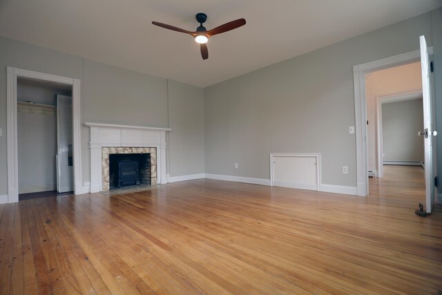 7 Middle St, Hallowell, ME 04347 - unfurnished living room with ceiling fan, light wood finished floors, a fireplace, and baseboards