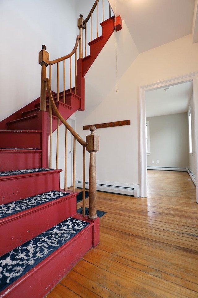 7 Middle St, Hallowell, ME 04347 - staircase with hardwood / wood-style flooring, a baseboard heating unit, and baseboards