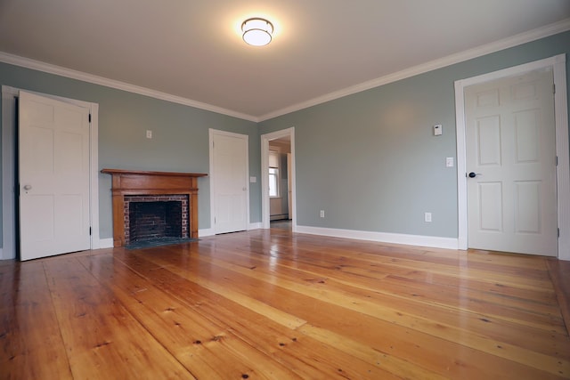 7 Middle St, Hallowell, ME 04347 - unfurnished living room with ornamental molding, light wood-style flooring, baseboards, and a brick fireplace