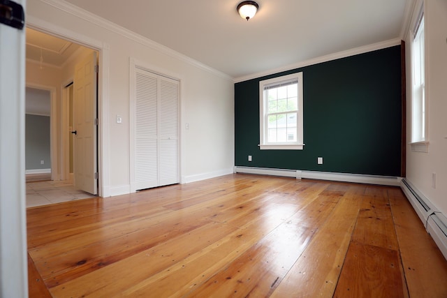 7 Middle St, Hallowell, ME 04347 - unfurnished bedroom with attic access, baseboard heating, light wood-style floors, and crown molding