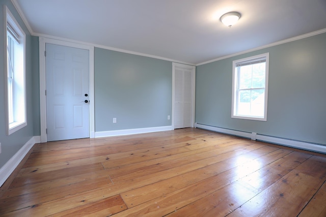 7 Middle St, Hallowell, ME 04347 - unfurnished room featuring a baseboard heating unit, crown molding, light wood finished floors, and baseboards