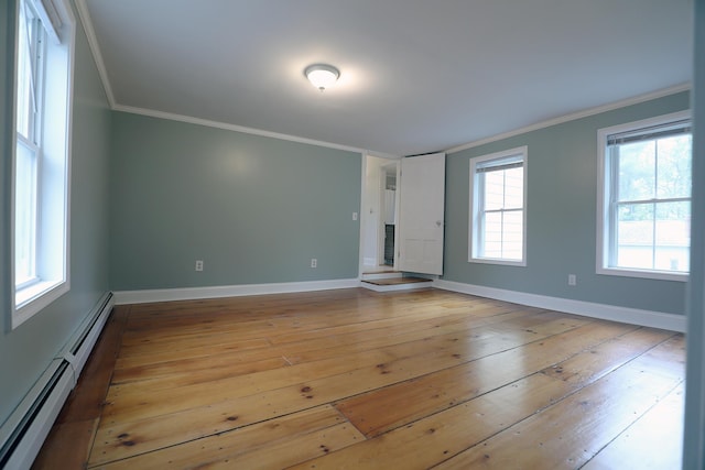 7 Middle St, Hallowell, ME 04347 - spare room featuring a baseboard heating unit, light wood-style flooring, ornamental molding, and baseboards