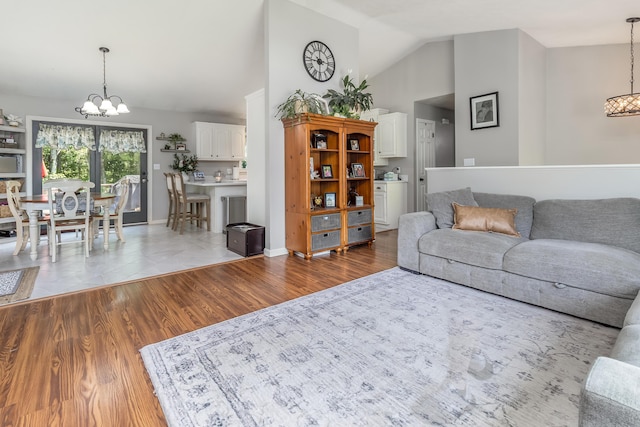 320 Grove St, Lewiston, ME 04240 - living area with a chandelier, wood finished floors, and high vaulted ceiling