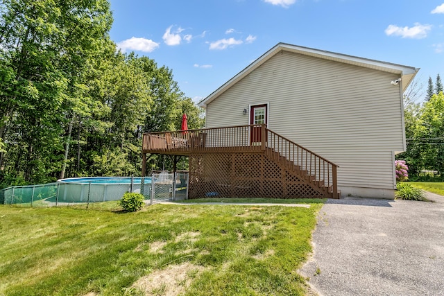 320 Grove St, Lewiston, ME 04240 - view of property exterior featuring a wooden deck, an outdoor pool, and a gate