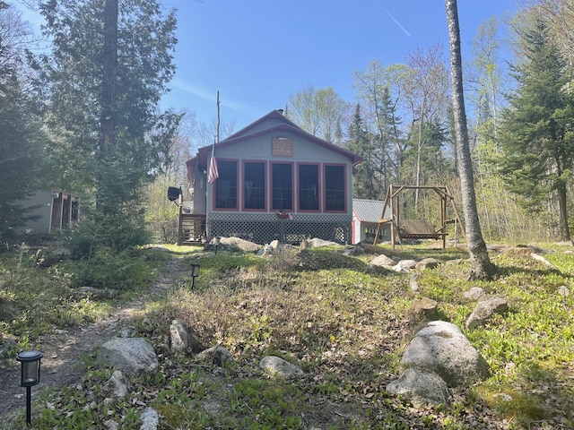 back of property featuring a sunroom