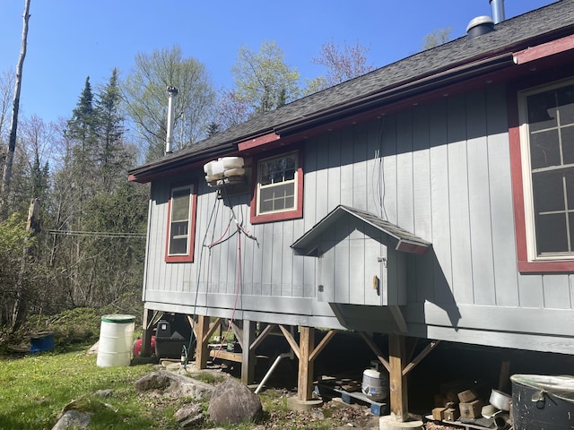 view of home's exterior with a shingled roof